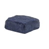A cake of natural indigo dye on a black background
