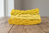Skeins of cotton plant-dyed with turmeric in shades of golden yellow