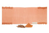 Indian Madder peach organic cotton yoga mat laid flat, with madder root sticks and powdered madder in front