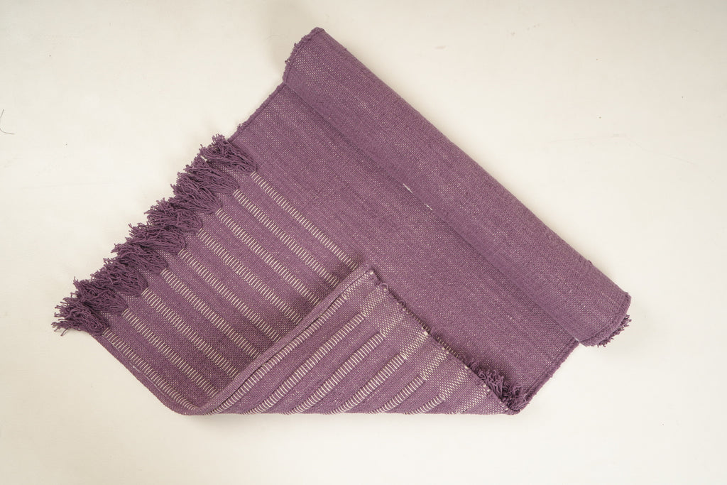 Dusky purple Sappanwood with Dark Siyahi yoga mat, folded back to show both sides and fringe