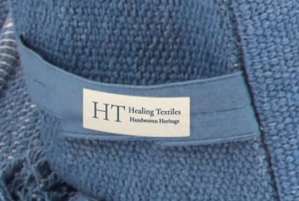 Close-up of the Healing Textiles label on an indigo blue woven cotton cover