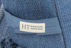 Close-up of the Healing Textiles label on an indigo blue woven cotton cover