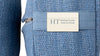 Close-up of an indigo yoga block showing the woven cotton texture, zip and Healing Textiles label