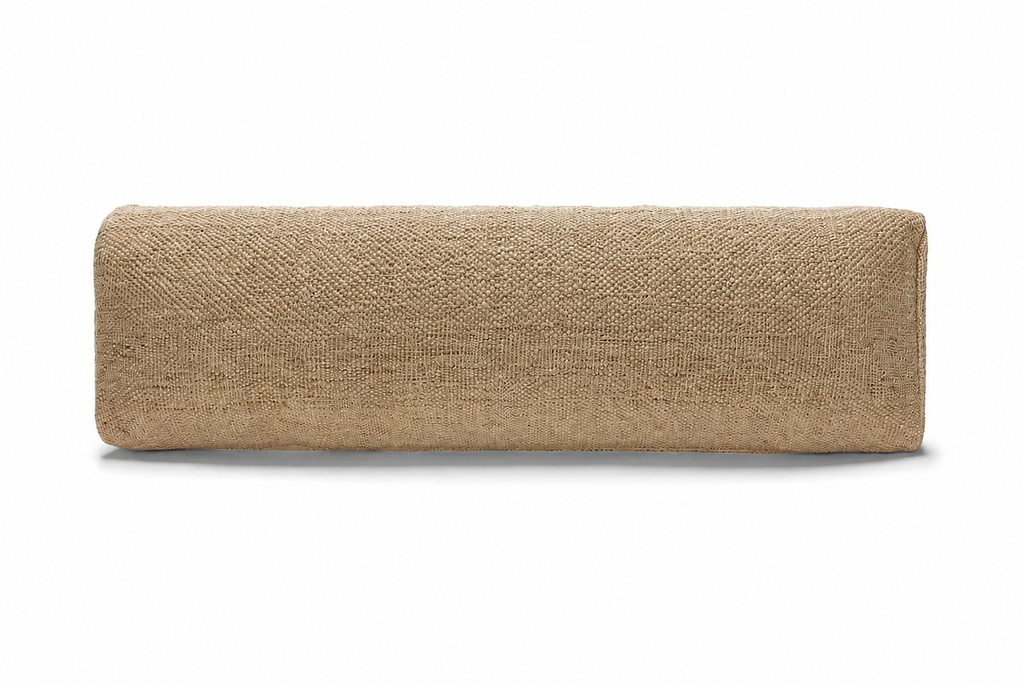Myrobalan pranayama pillow seen side-on, showing its long, slim shape and woven cotton cover