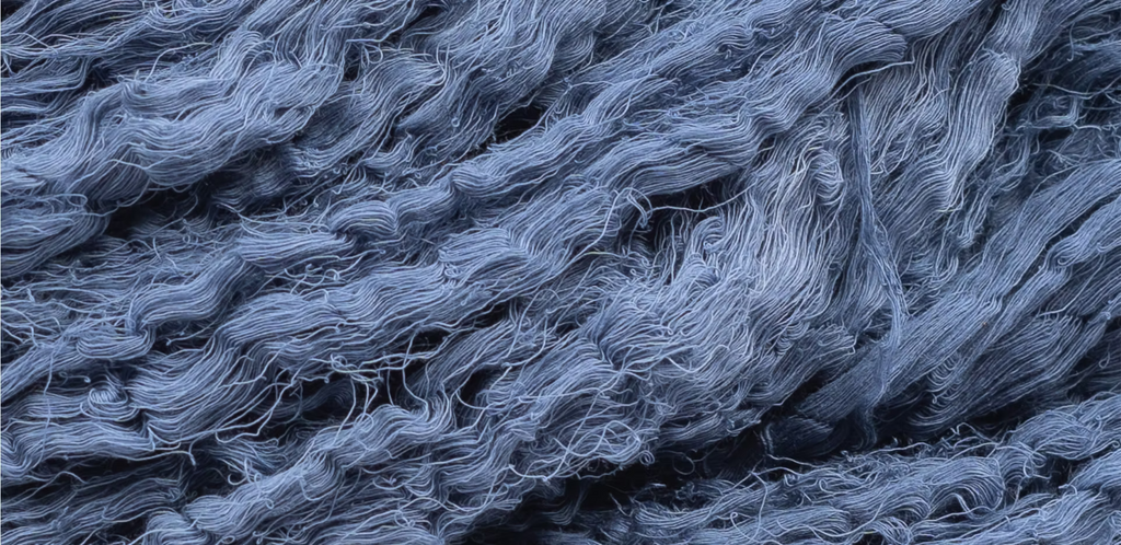 lose-up of raw organic cotton fabric naturally dyed with indigo plant dye using traditional Ayurvastra Ayurveda methods
