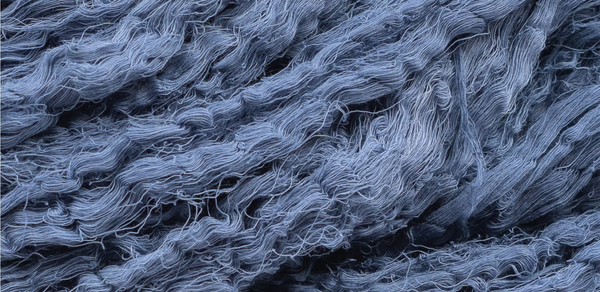 lose-up of raw organic cotton fabric naturally dyed with indigo plant dye using traditional Ayurvastra Ayurveda methods