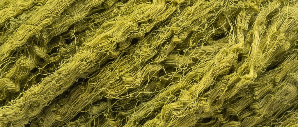 Close-up of green cotton threads dyed with indigo and turmeric