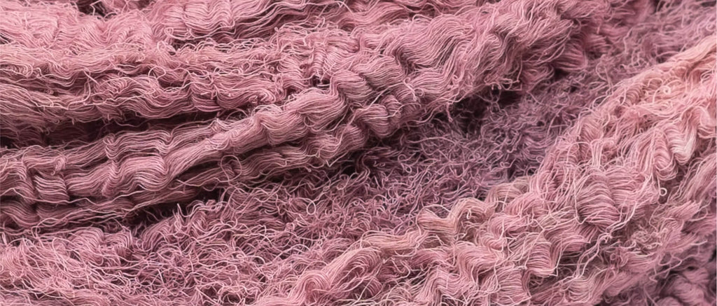Close-up of rose-red sappanwood-dyed cotton threads