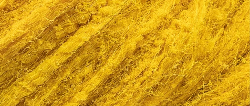 Close-up of golden yellow turmeric-dyed cotton threads